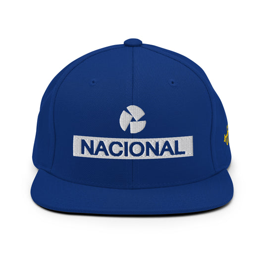 Blue Nacional snapback hat inspired by classic motorsport heritage. Embroidered logo with a structured fit for a bold statement.